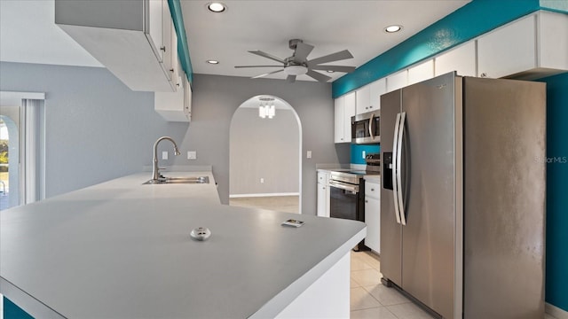 kitchen with white cabinets, sink, ceiling fan, light tile patterned flooring, and stainless steel appliances