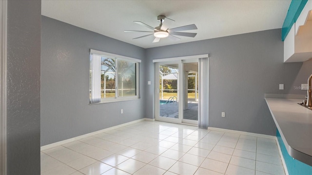 unfurnished dining area with light tile patterned floors and ceiling fan