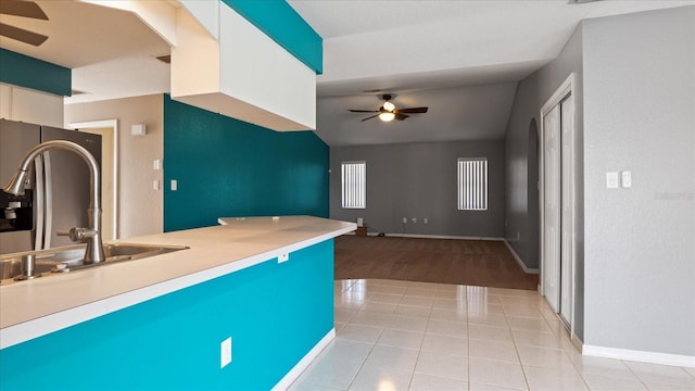 kitchen featuring white cabinetry, ceiling fan, sink, and light hardwood / wood-style floors