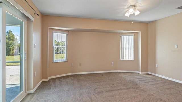 spare room with carpet flooring and ceiling fan