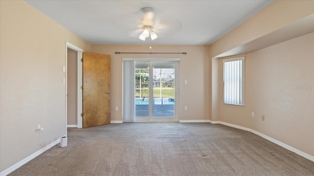 spare room featuring ceiling fan and light colored carpet