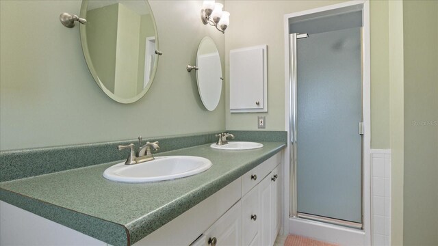 bathroom featuring vanity and an enclosed shower