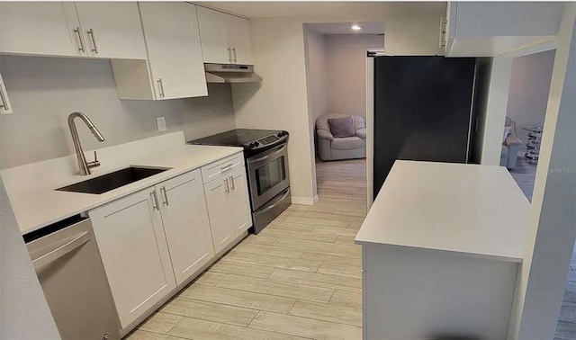 kitchen with white cabinets, stainless steel appliances, and sink