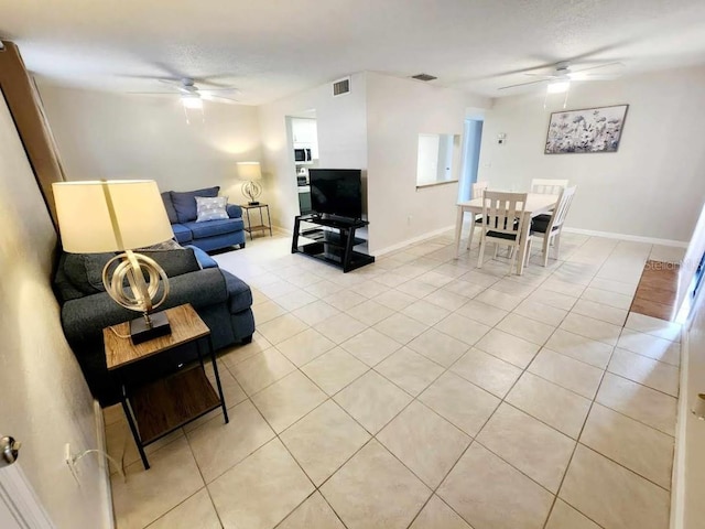 tiled living room featuring ceiling fan