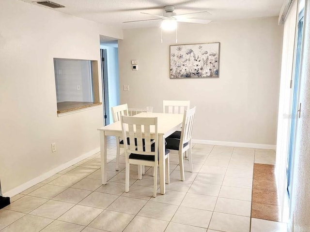 tiled dining room with ceiling fan