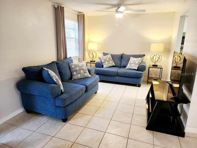 living room featuring light tile patterned floors, a textured ceiling, and ceiling fan