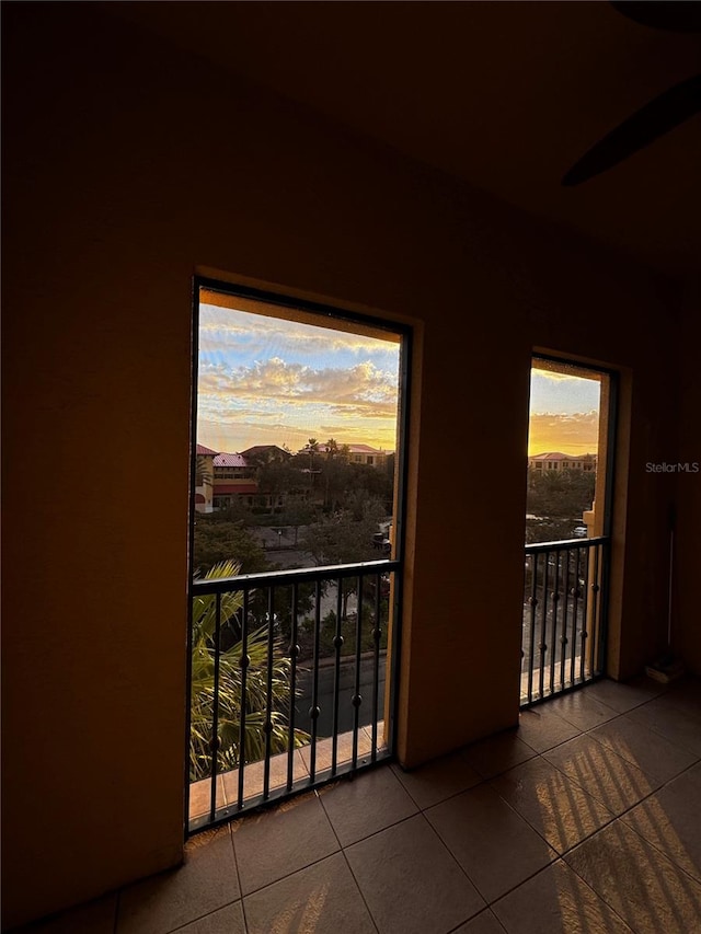 balcony at dusk featuring ceiling fan