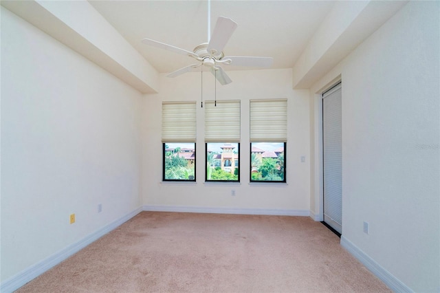 unfurnished room featuring ceiling fan and light colored carpet