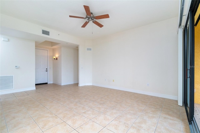 tiled empty room featuring ceiling fan