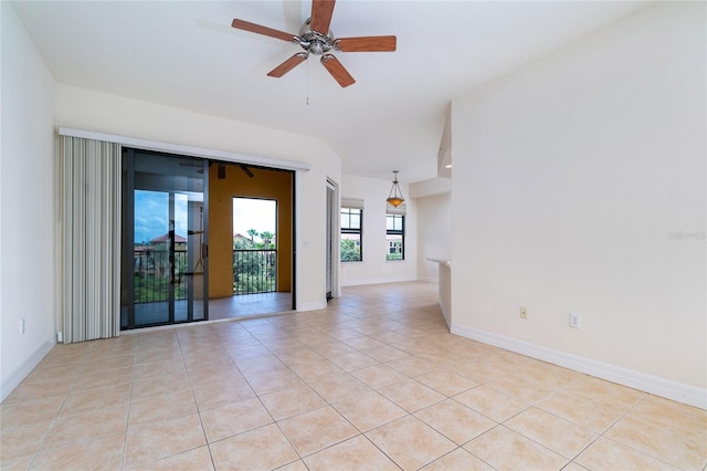 tiled empty room featuring ceiling fan