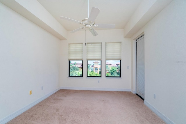 carpeted empty room featuring ceiling fan