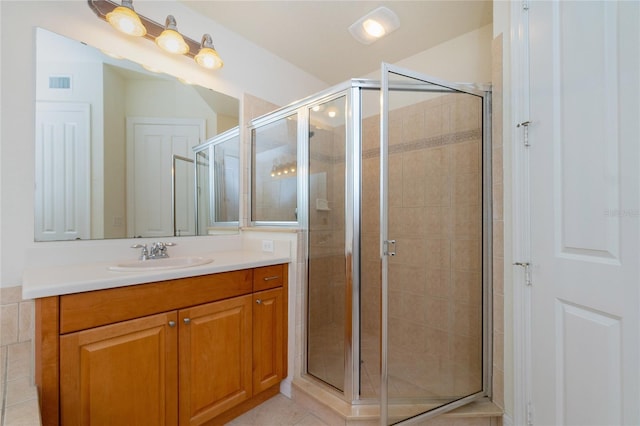 bathroom featuring vanity, tile patterned floors, and an enclosed shower