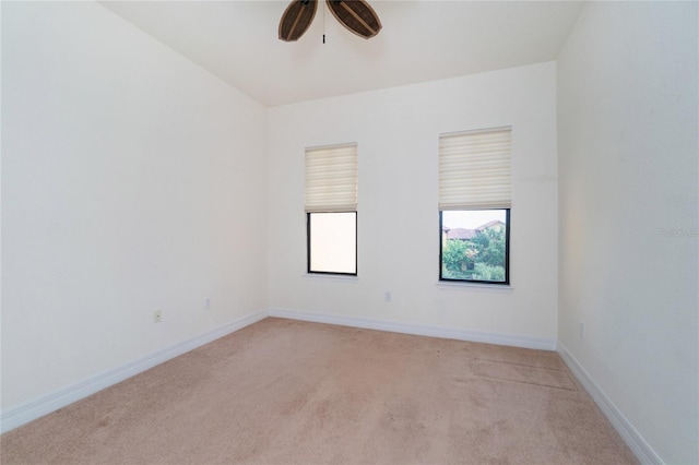 carpeted spare room featuring ceiling fan