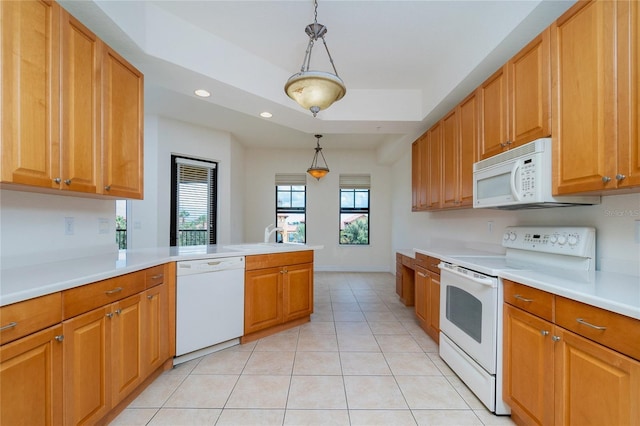 kitchen featuring kitchen peninsula, light tile patterned floors, decorative light fixtures, and white appliances