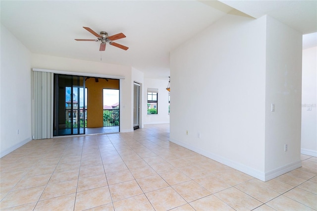 tiled spare room featuring ceiling fan