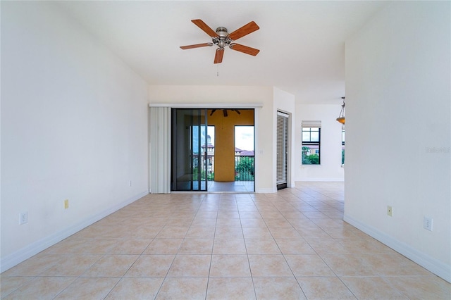 tiled spare room with ceiling fan