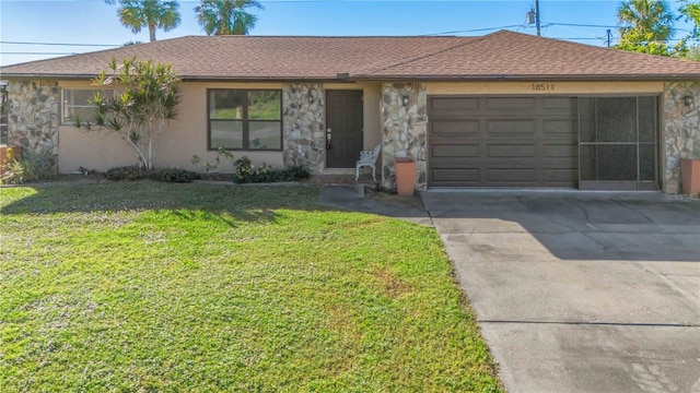 single story home featuring a front lawn and a garage