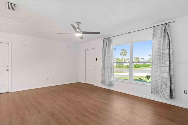 spare room with ceiling fan and dark hardwood / wood-style flooring