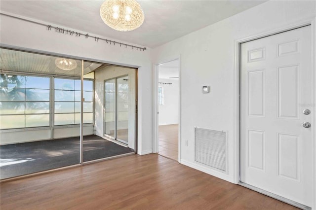 interior space with a closet, an inviting chandelier, and hardwood / wood-style flooring