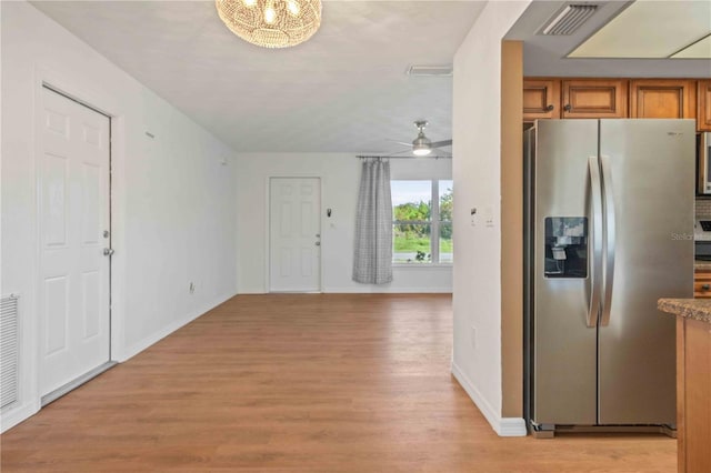 kitchen featuring stainless steel fridge with ice dispenser, light hardwood / wood-style floors, and ceiling fan