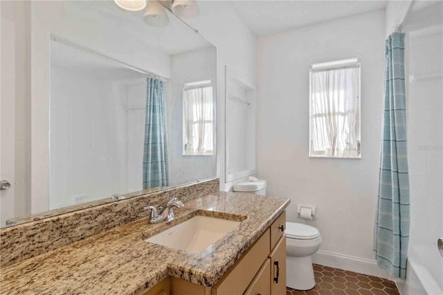 full bathroom with tile patterned flooring, vanity, a healthy amount of sunlight, and toilet