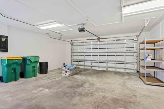 garage with electric panel and a garage door opener