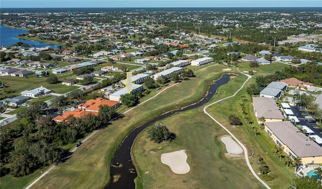 birds eye view of property featuring view of golf course, a water view, and a residential view