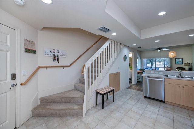 kitchen with ceiling fan, dishwasher, sink, hanging light fixtures, and light brown cabinetry