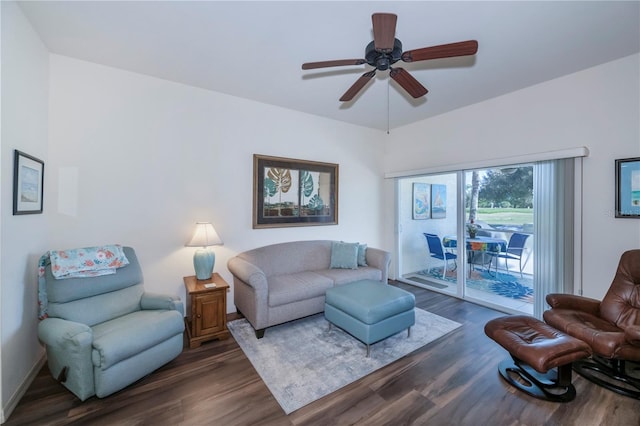 living room featuring ceiling fan and dark hardwood / wood-style floors