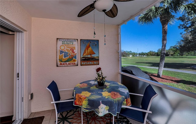 dining area featuring light tile patterned floors, a ceiling fan, and a textured wall