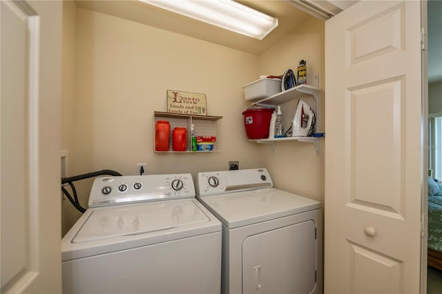 clothes washing area with washing machine and clothes dryer