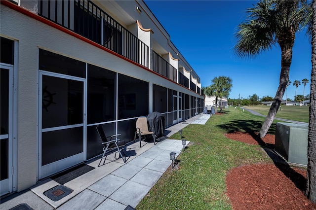 exterior space featuring a lawn and a patio