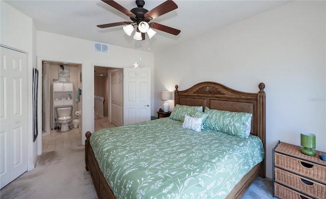 carpeted bedroom featuring visible vents, ceiling fan, and ensuite bathroom