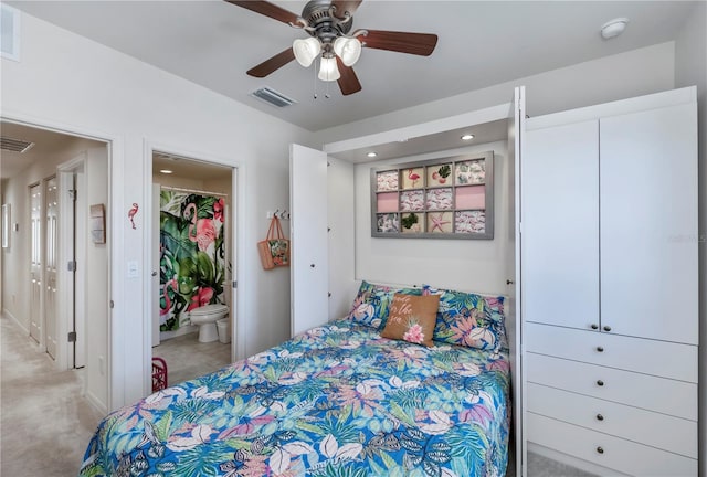 carpeted bedroom with connected bathroom and ceiling fan