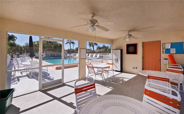 sunroom featuring ceiling fan