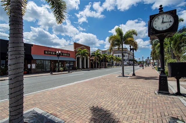 view of street featuring street lighting, curbs, and sidewalks