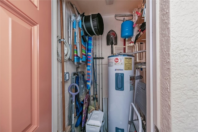 utility room featuring electric water heater