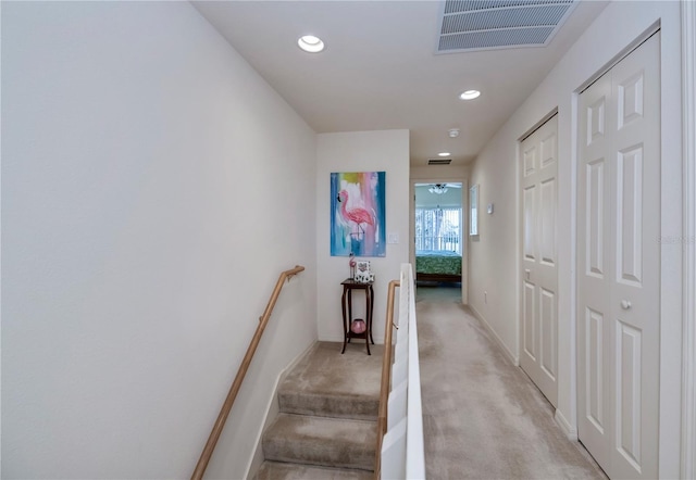 stairway with carpet floors, recessed lighting, visible vents, and baseboards