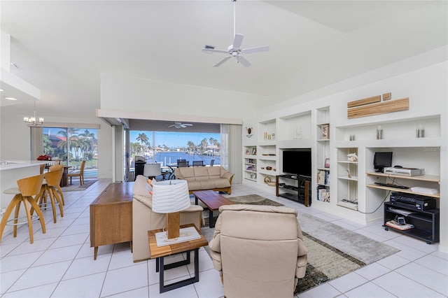 tiled living room with built in features, ceiling fan with notable chandelier, and lofted ceiling