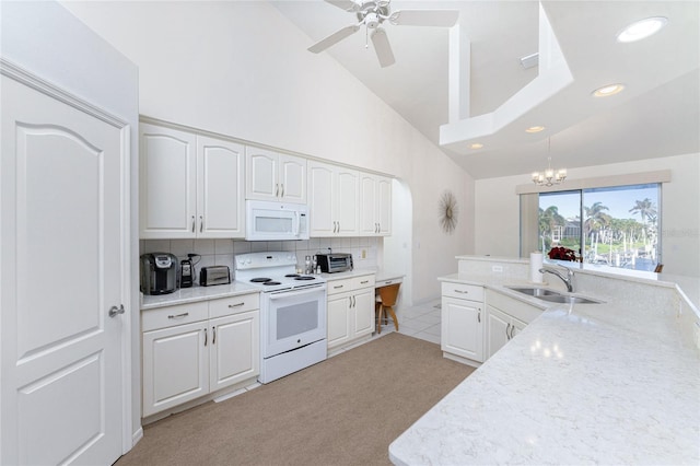 kitchen with white cabinetry, light colored carpet, and white appliances