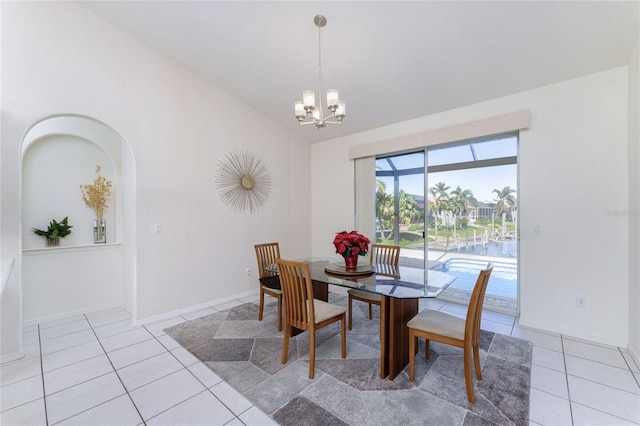 dining room with light tile patterned floors and an inviting chandelier