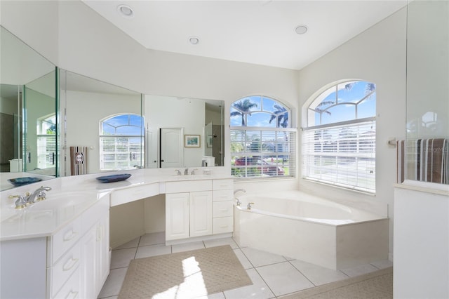 bathroom featuring a tub, tile patterned flooring, and vanity