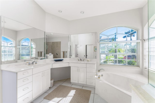 bathroom with plus walk in shower, vanity, tile patterned floors, and plenty of natural light