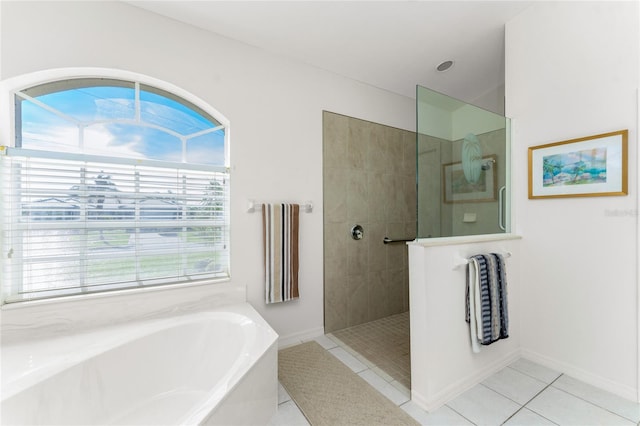 bathroom featuring tile patterned floors, plenty of natural light, and independent shower and bath