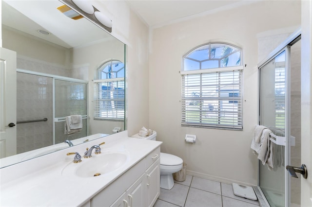 bathroom with tile patterned flooring, vanity, toilet, and a shower with shower door