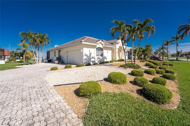 mediterranean / spanish home with a garage