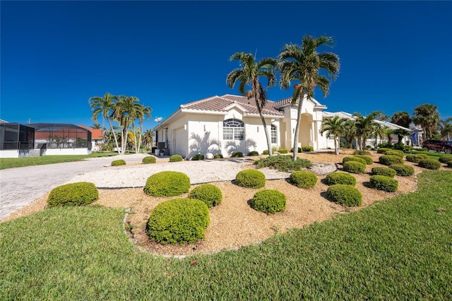 mediterranean / spanish-style house with a front lawn and a garage