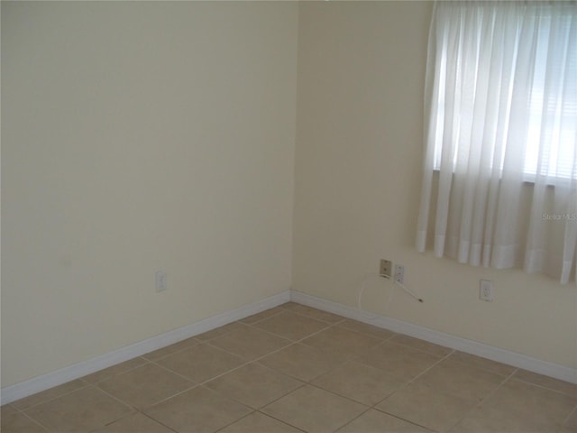 spare room with light tile patterned floors