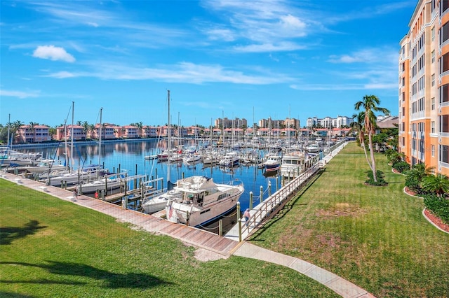 dock area featuring a lawn and a water view