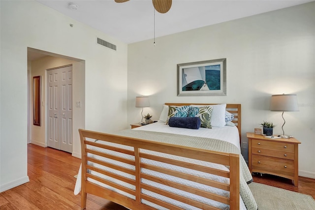 bedroom with light wood-type flooring, a closet, and ceiling fan